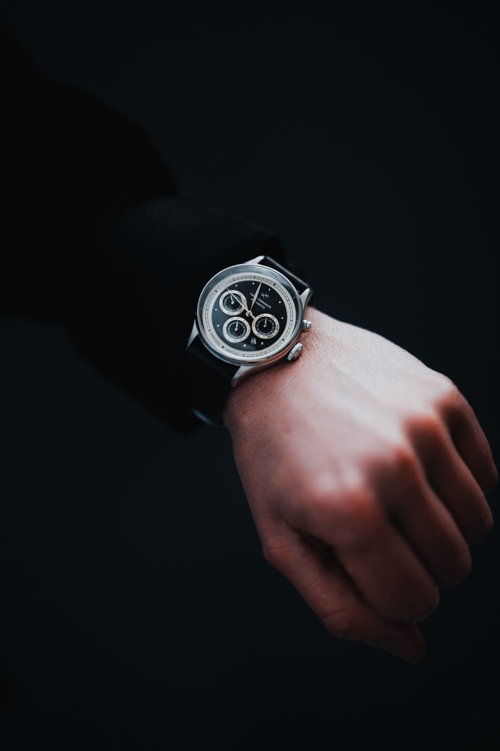 1564 Chronodate Automatic by AV86 with vintage chronograph dial, sapphire crystal, and black leather strap on wrist in minimalist setting