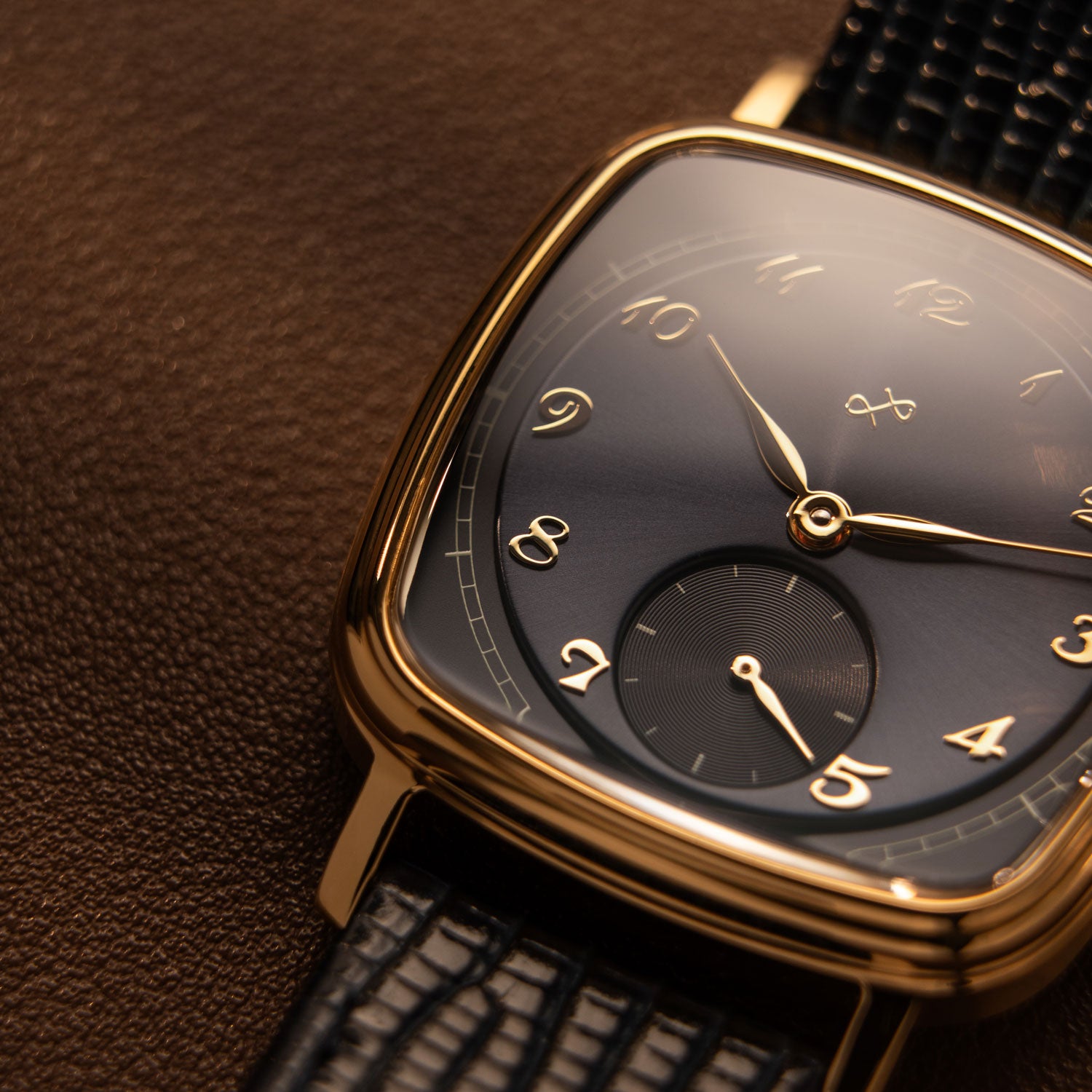 AV86 dress watch with curved sapphire crystal, rounded square case, mechanical small seconds, and textured leather strap detail.