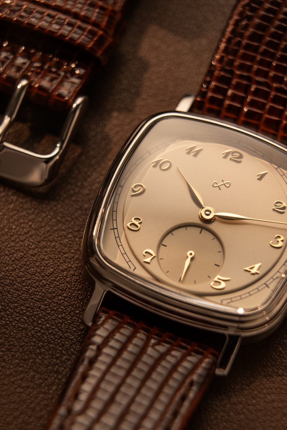 Close-up of 1954 Amalfi Mechanical, Steel / Off White watch with brown textured leather strap by AV86, highlighting vintage-inspired detail.