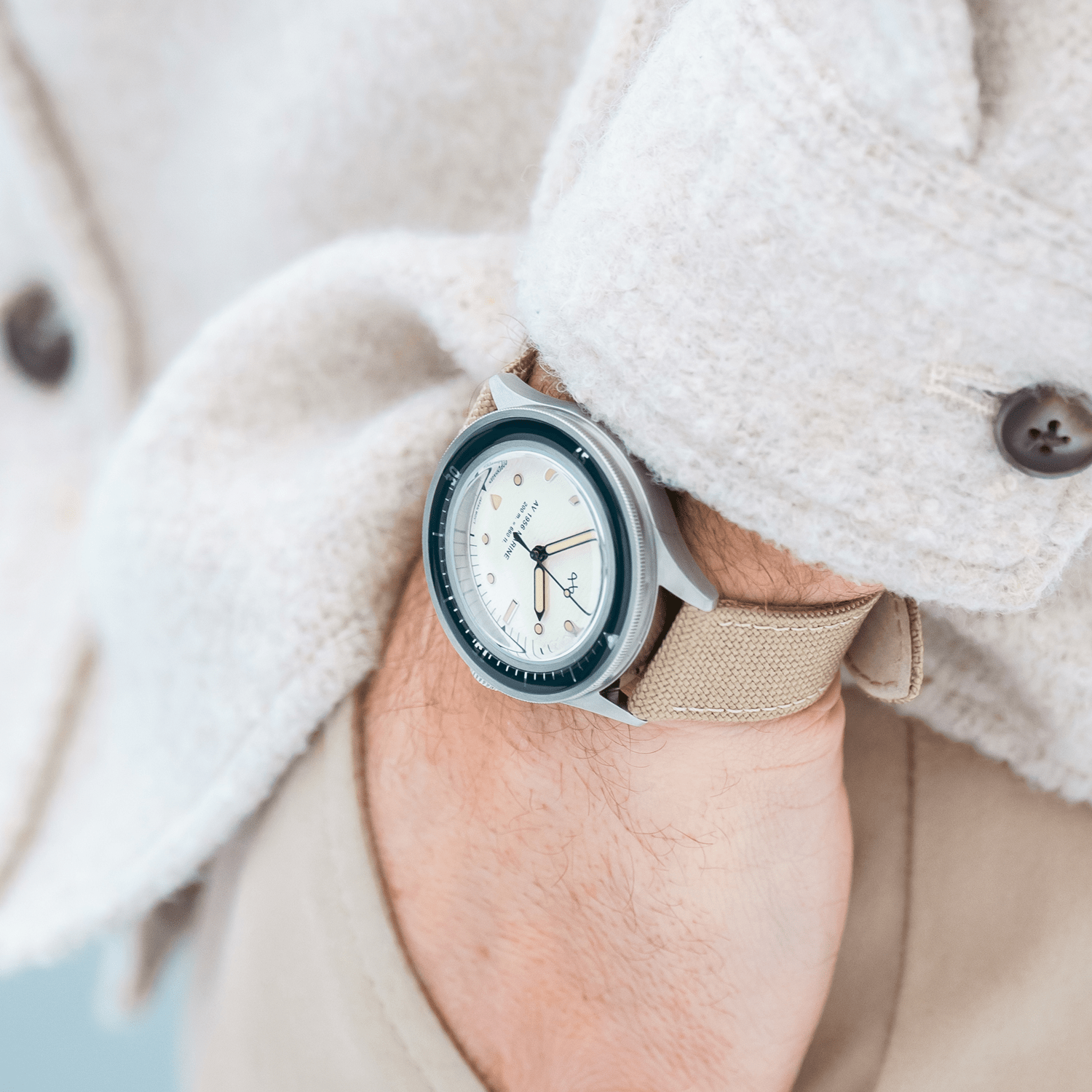 1956 Marine by AV86 vintage-inspired diver with acrylic bezel, luminous markers, and beige fabric strap on wrist
