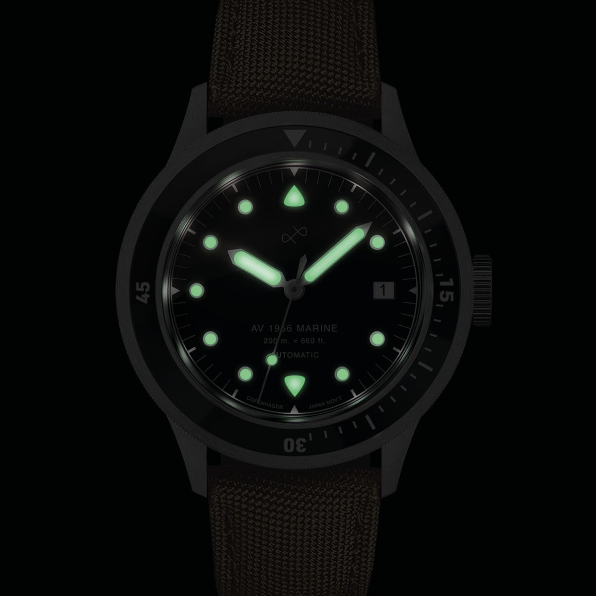 1956 Marine Automatic, Steel / Black with glowing markers and hands, vintage-inspired watch by AV86 in low light setting