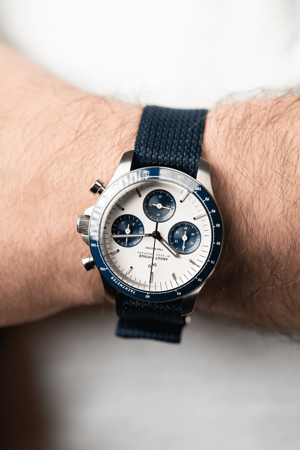 1960 Racing Chronograph by AV86 with vintage-inspired dial, sapphire crystal, tachymeter bezel, and navy fabric strap on wrist
