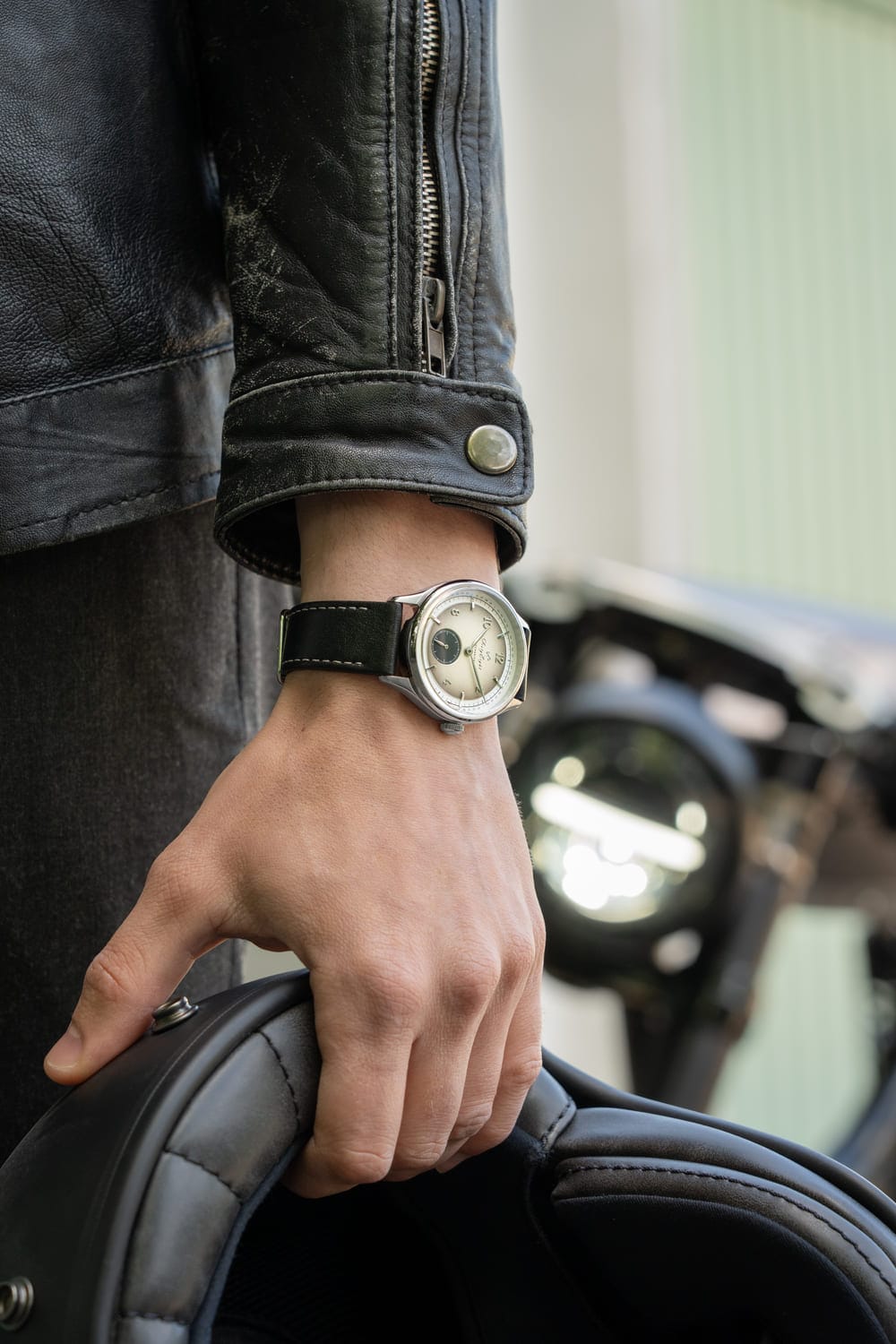 1968 Mechanical (Hand-Wound) by AV86 vintage-inspired dress watch with sapphire crystal and black leather strap worn with leather jacket