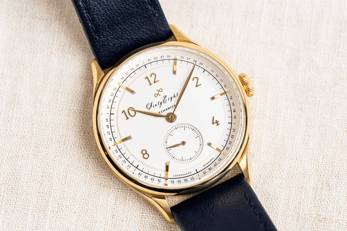 1968 Mechanical by AV86 vintage-inspired automatic with sapphire crystal, gold case, white dial, and black leather strap