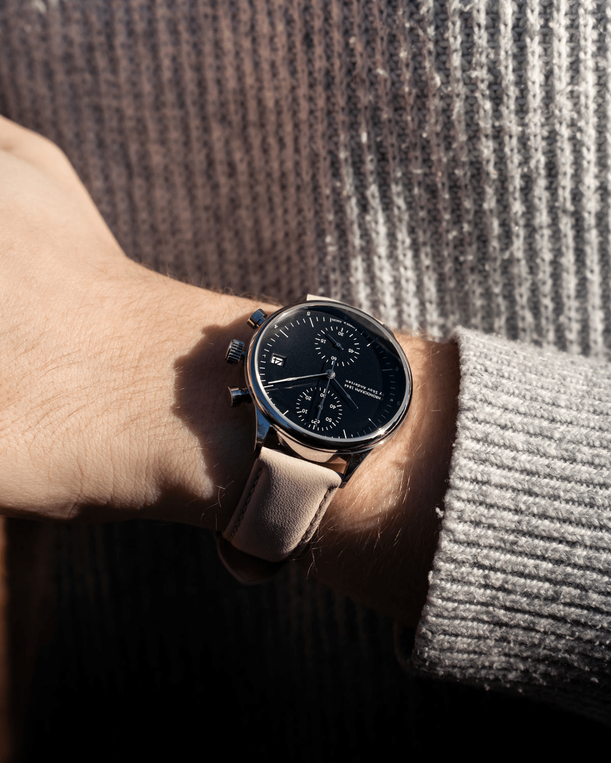1844 Chronograph by AV86 with sapphire crystal, precision black dial, chronograph subdials, and beige leather strap on wrist