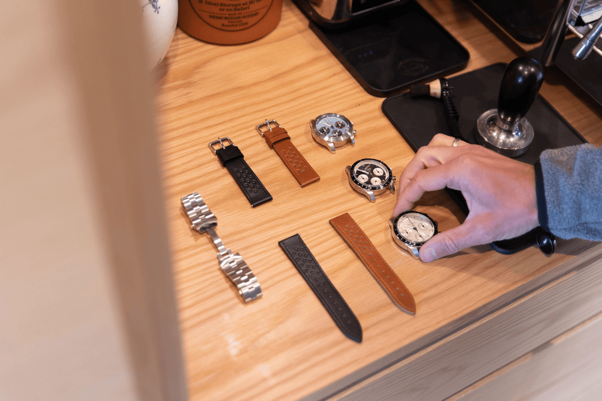 1960 Racing Chronograph by AV86 vintage-inspired chronograph with sapphire crystal, leather straps, and steel case on wood surface