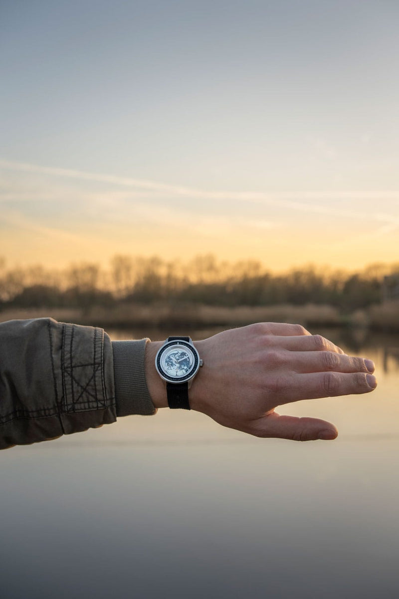 Earthrise WWF Partnership、AV86製 オートマチック/2025年モデル。自動巻きムーブメント、Sapphire Crystal、ブラックのラバーストラップを備え、夕暮れの屋外で撮影