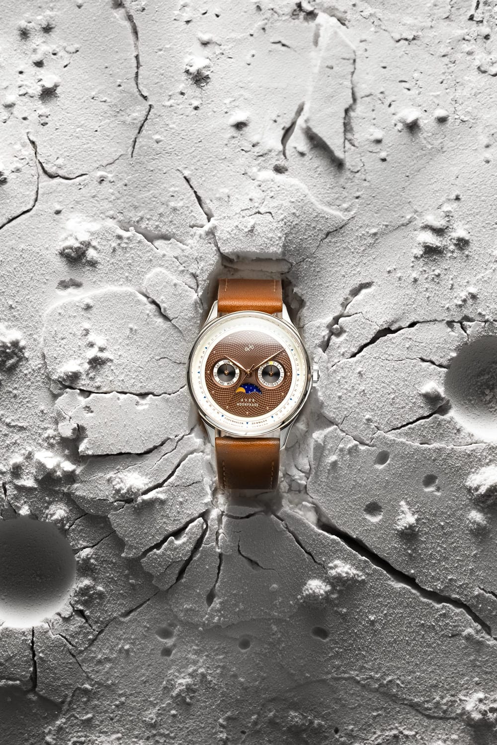 1968 Moonphase by AV86 with vintage-inspired moonphase dial, sapphire crystal, and brown leather strap on textured lunar surface