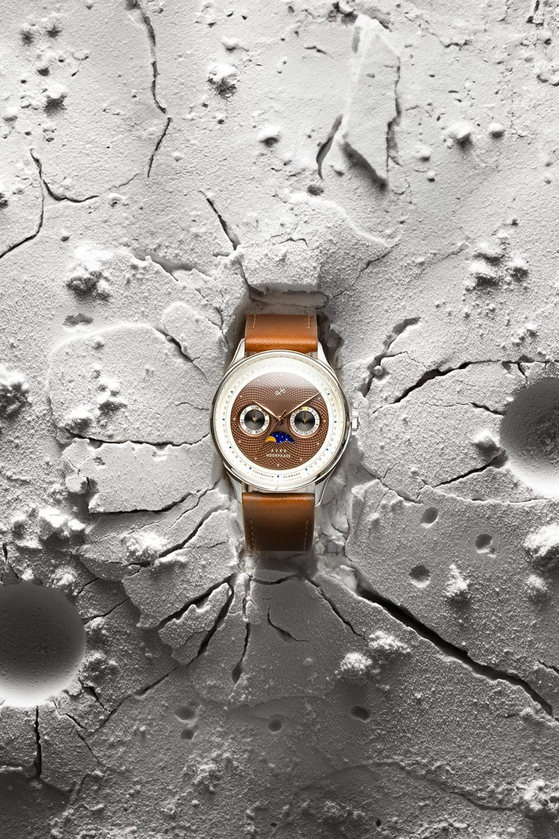 1968 Moonphase by AV86 with vintage-inspired moonphase dial, sapphire crystal, and brown leather strap on textured lunar surface