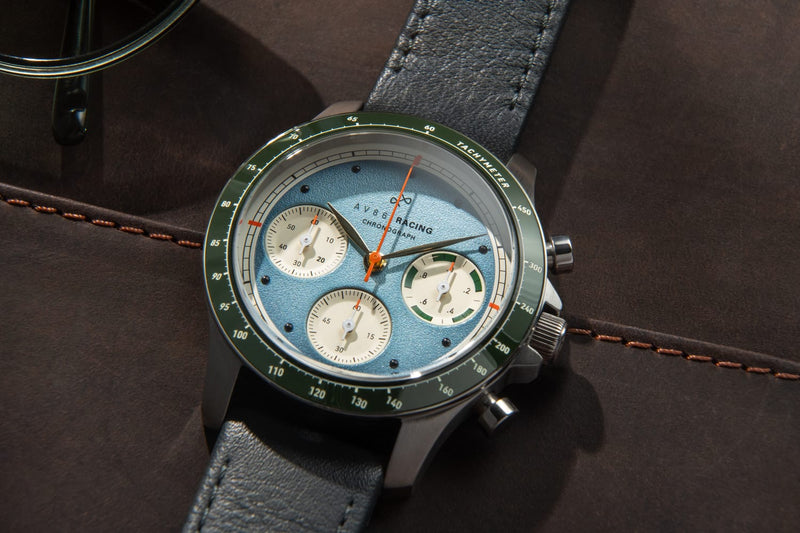 AV86 1960 Racing Chronograph, Steel / Sky Blue & Green quartz watch with blue dial, green tachymeter bezel, three subdials, and leather strap