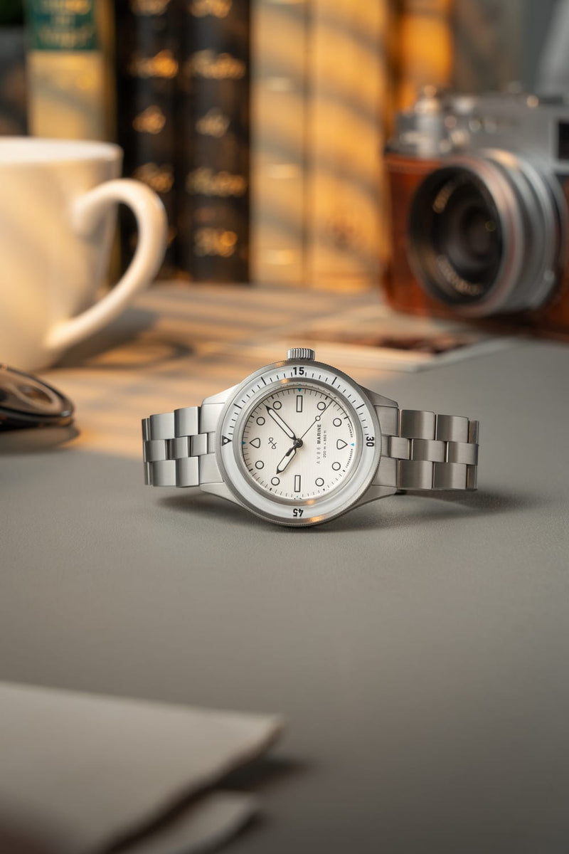 1956 Marine by AV86 vintage-inspired diver watch with sapphire crystal, compass bezel, and polished steel bracelet strap