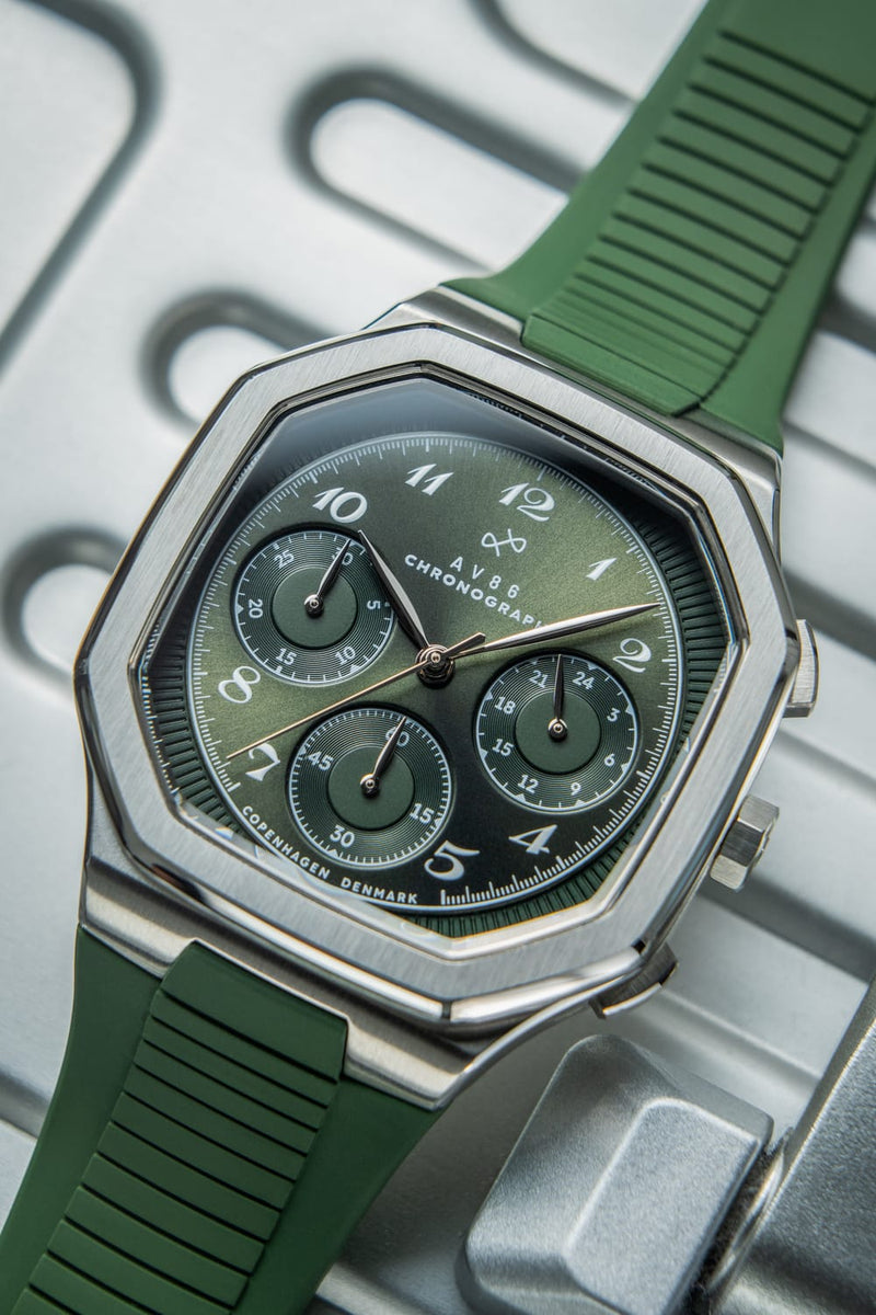 1904 Chronograph by AV86 with vintage-inspired angular case, sapphire crystal, chronograph dial, and green rubber strap