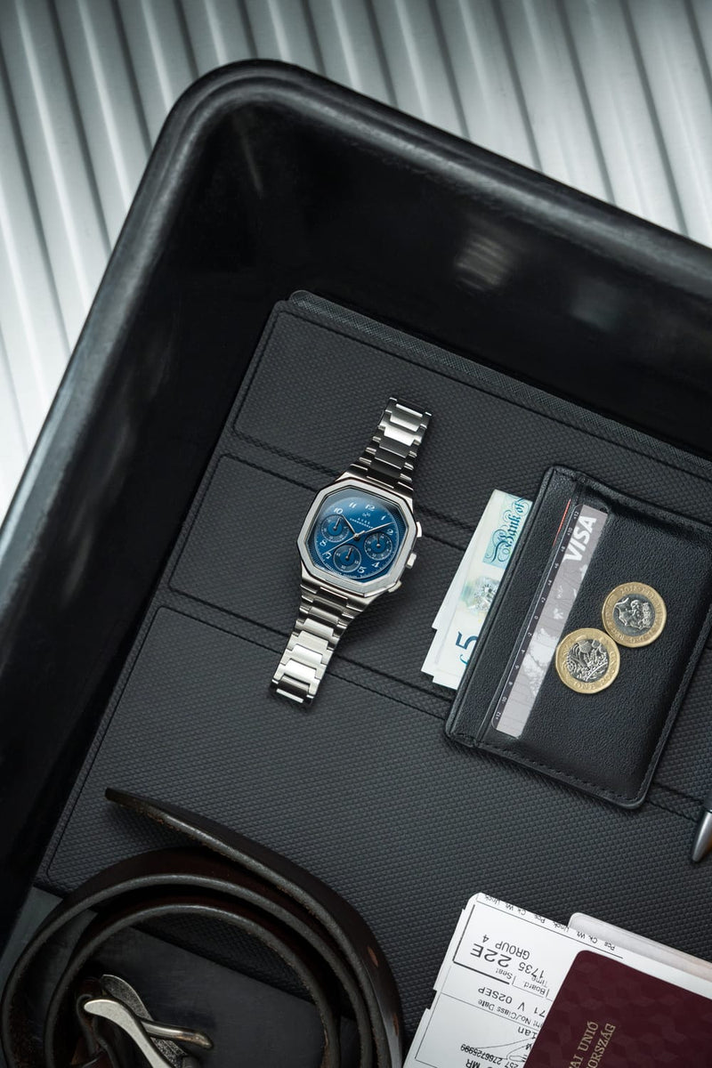 1904 Chronograph by AV86 with angular case, sapphire crystal, chronograph dial, and polished metal bracelet strap in a sleek tray setting