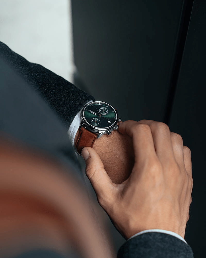 1815 Chronograph by AV86 with vintage-inspired dial, sapphire crystal, polished steel case, and brown leather strap on wrist