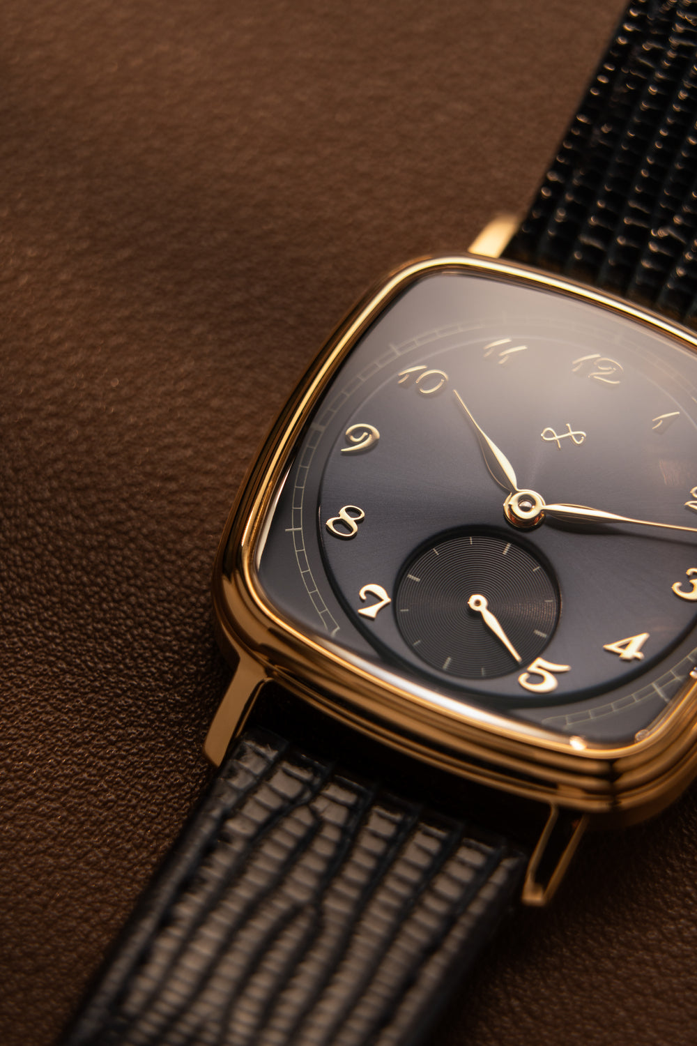 AV86 dress watch with curved sapphire crystal, cushion case, delicate vintage-inspired dial, and textured leather strap close-up.