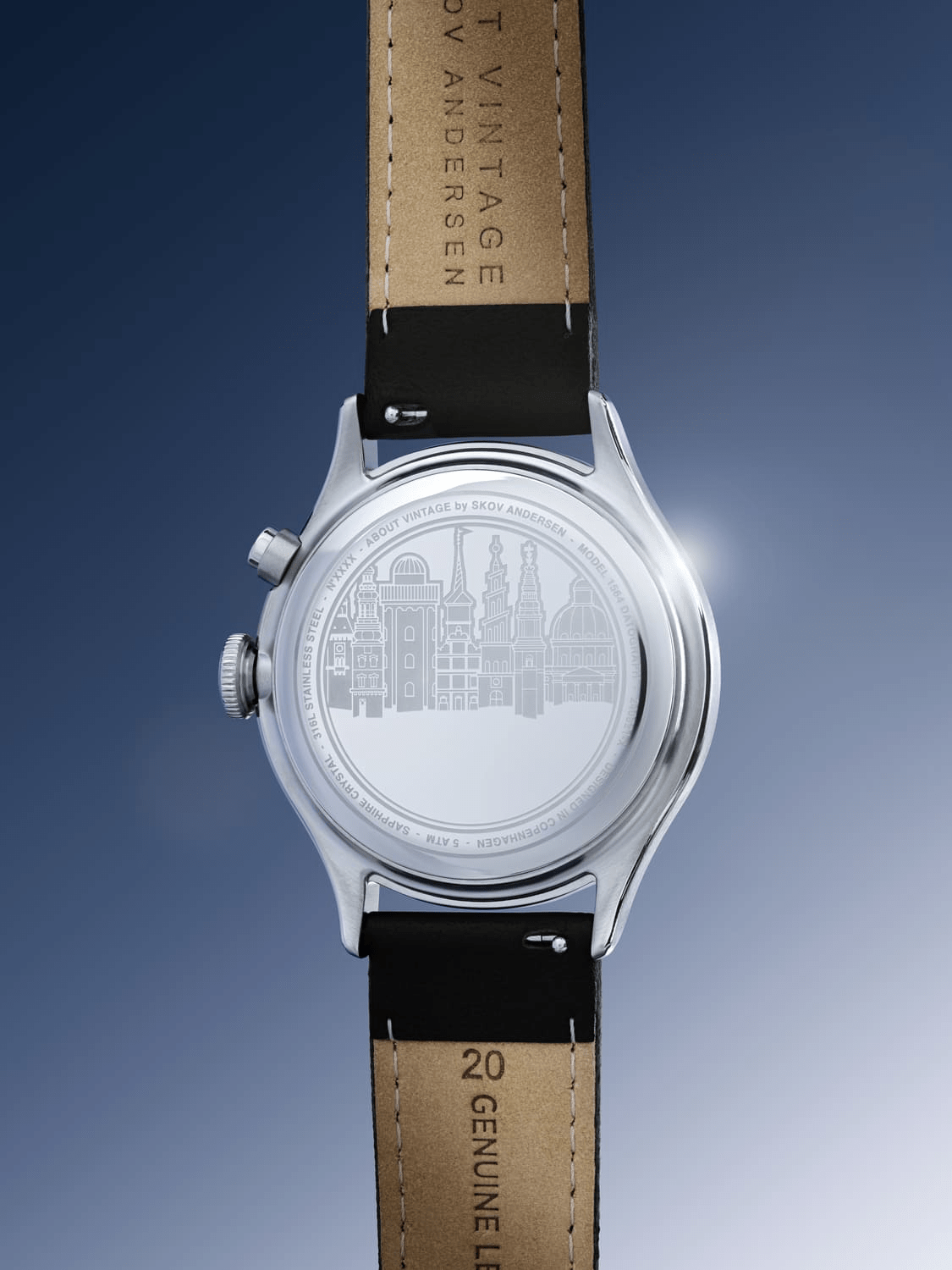 1564 Chronodate Automatic by AV86 showing polished stainless steel case back with cityscape engraving and black leather strap