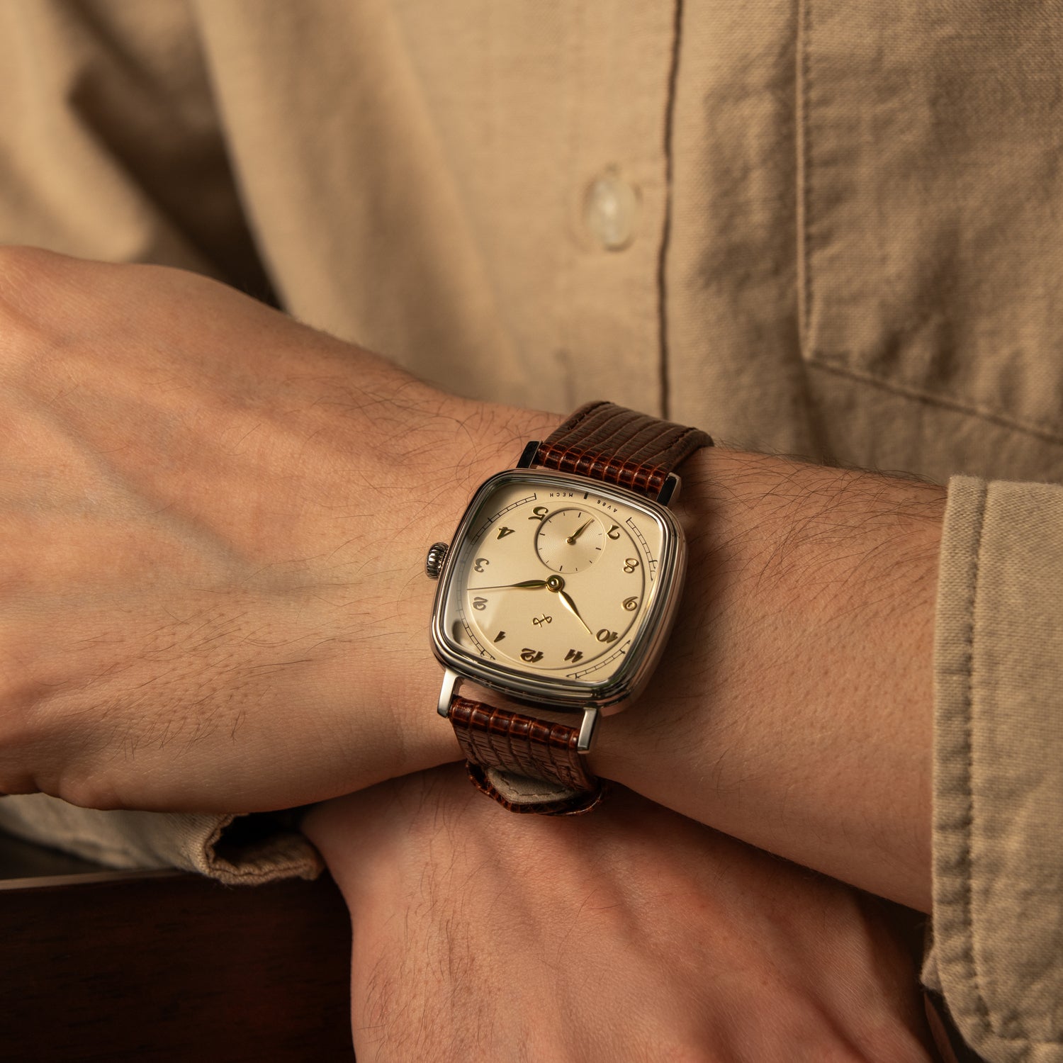 AV86 vintage-inspired dress watch with cushion case, mechanical small seconds, and textured leather strap worn with casual button-up shirt.