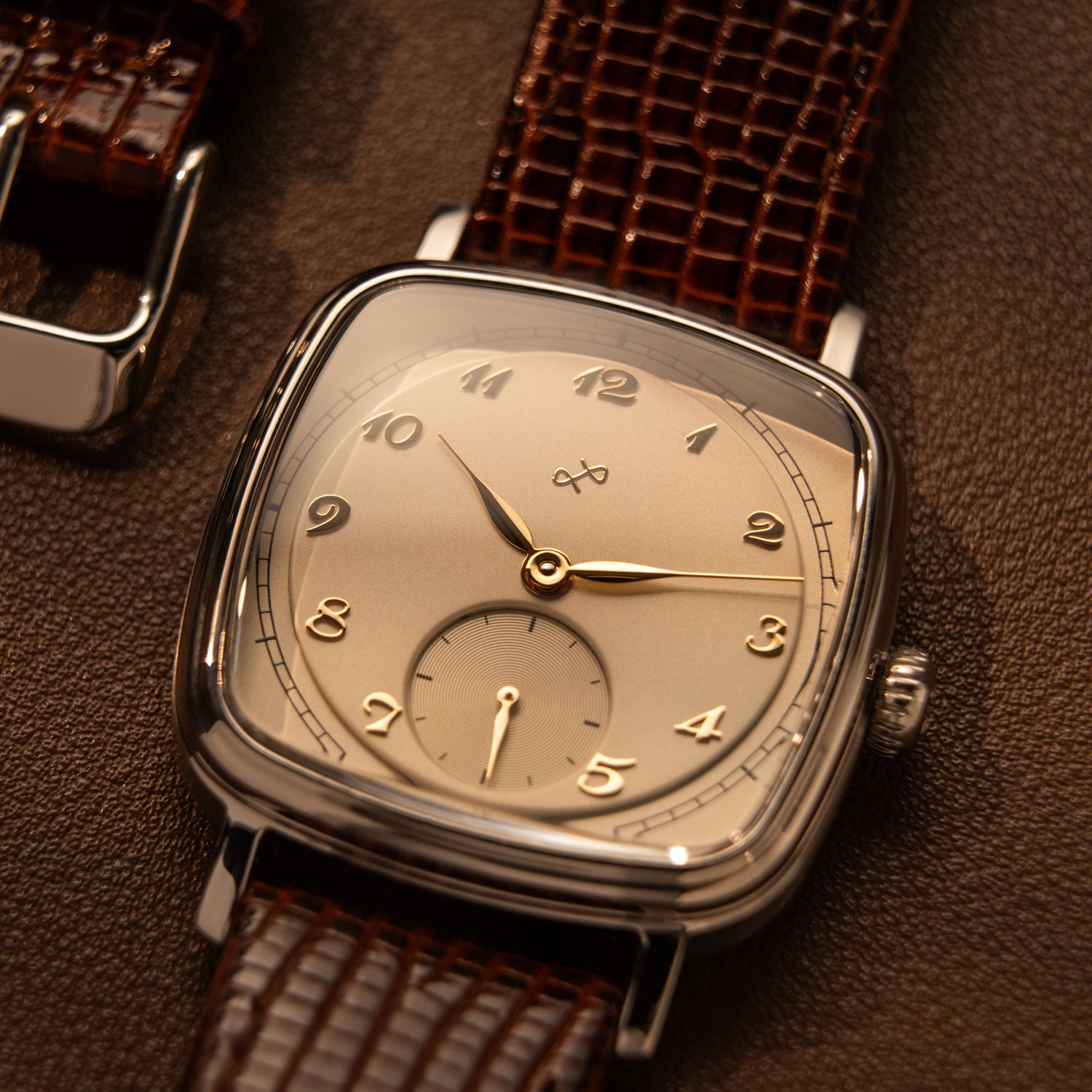 Dress watch by AV86 featuring a polished rounded square case, mechanical small seconds, curved sapphire crystal, and textured leather strap.