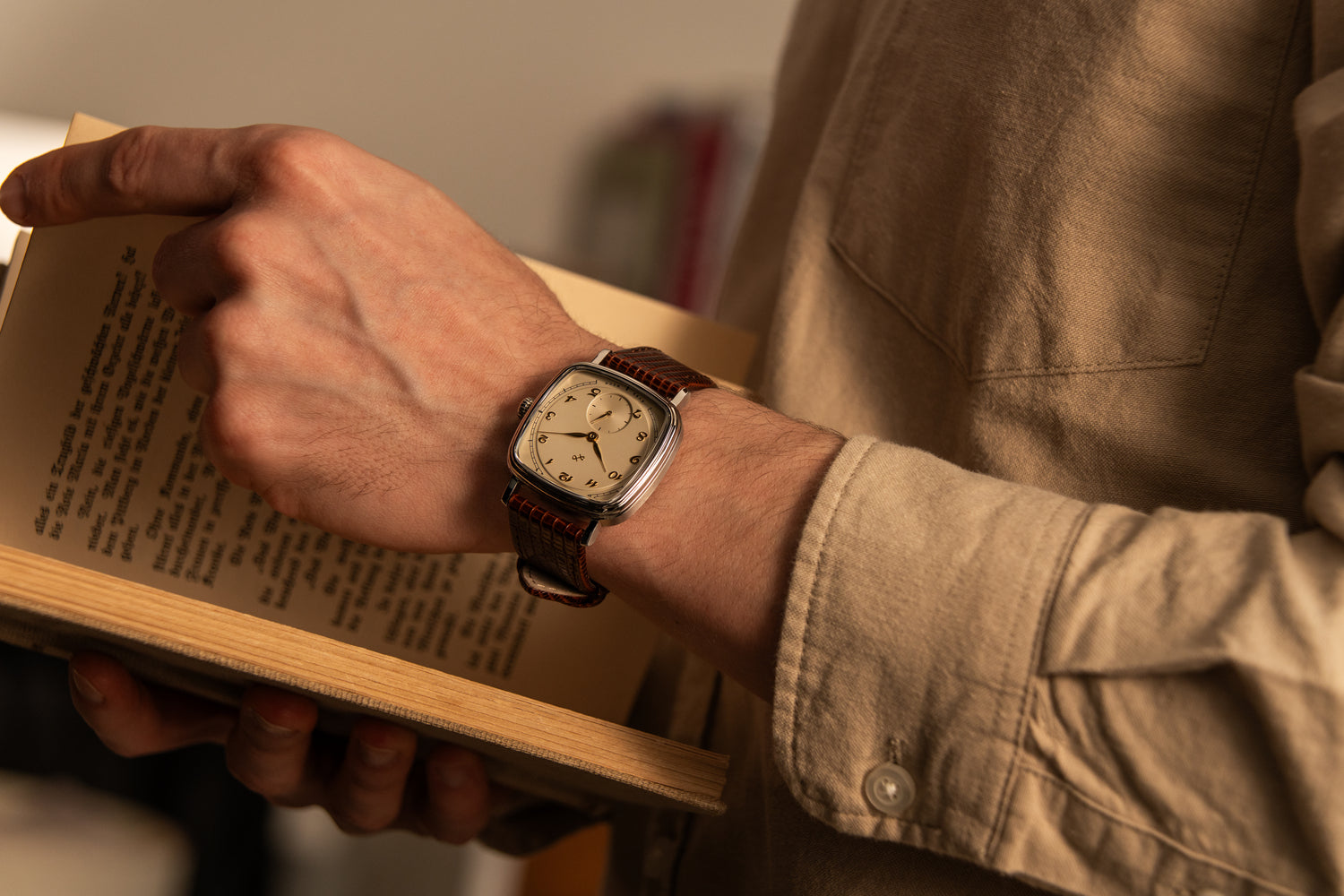 1954 Amalfi Mechanical by AV86 with mechanical movement, cushion case, vintage dial, and textured leather strap in relaxed indoor setting