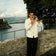 Man in elegant cream cardigan and black trousers by the sea wearing 1954 Amalfi Mechanical gold watch by AV86