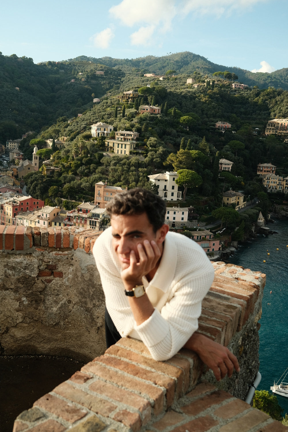 1954 Amalfi Mechanical by AV86 worn with knitwear overlooking Italian Riviera, embodying sophisticated leisure and timeless coastal allure