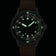 1956 Marine Automatic, Steel / Green by AV86 with luminous markers, steel case, green accents, and brown leather strap at night