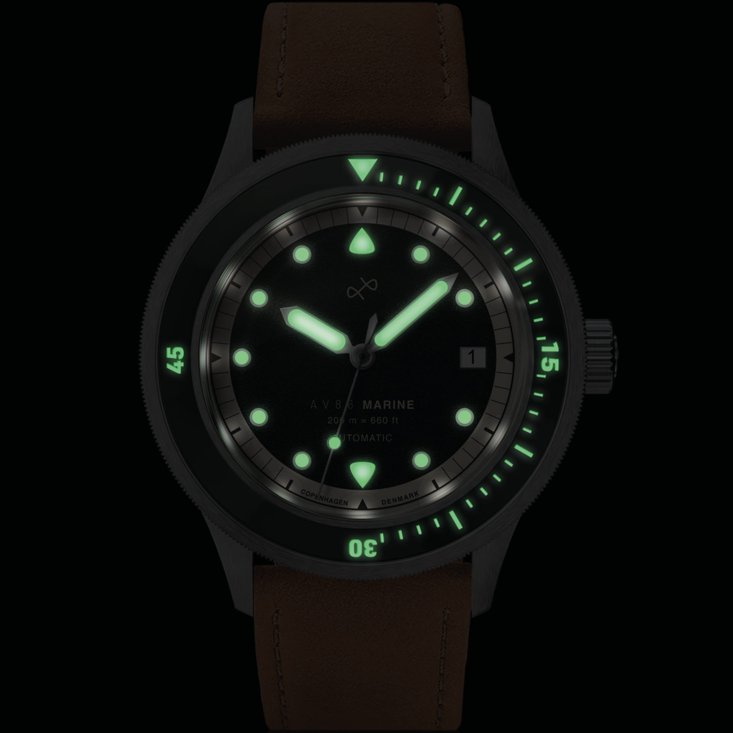 1956 Marine Automatic, Steel / Green by AV86 with luminous markers, steel case, green accents, and brown leather strap at night