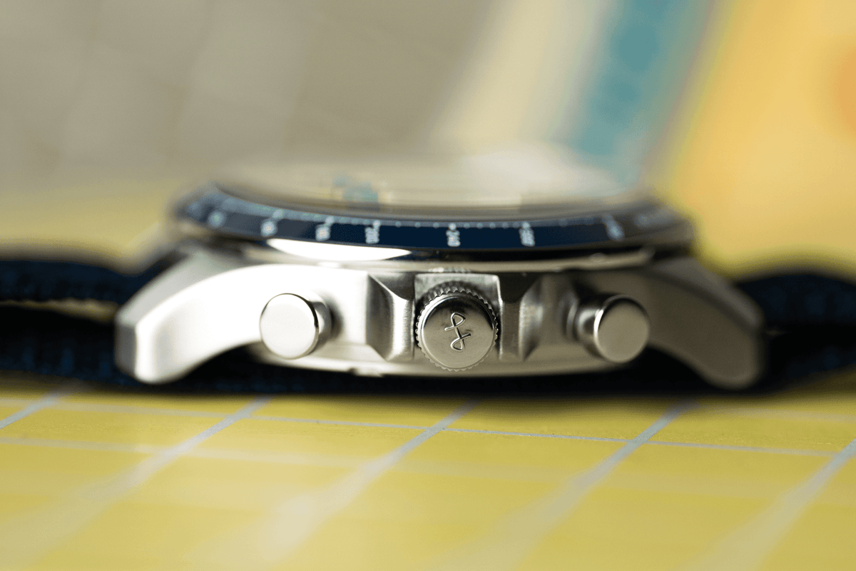 1960 Racing Chronograph by AV86 with polished crown, pushers, sapphire crystal, and textured navy leather strap