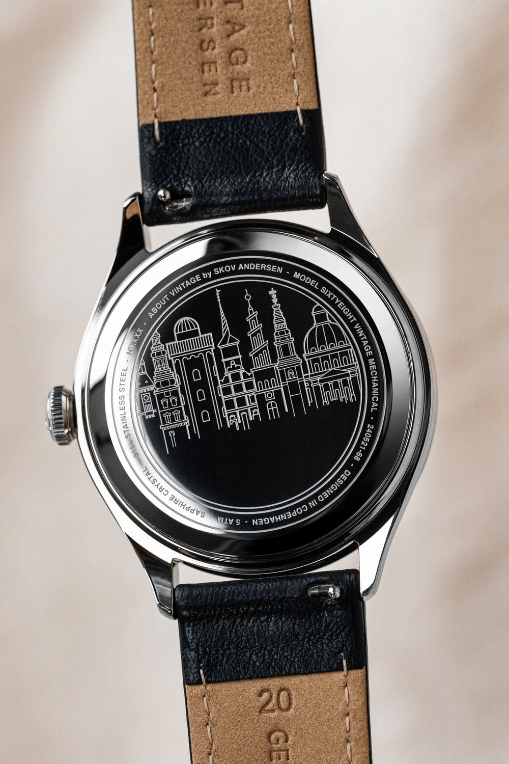 1968 Mechanical by AV86 with intricate cityscape engraving, stainless steel case back, sapphire crystal, and leather strap