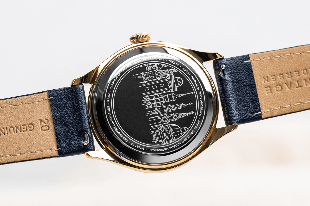 1968 Mechanical by AV86 automatic watch showcasing engraved case back with detailed cityscape and leather strap