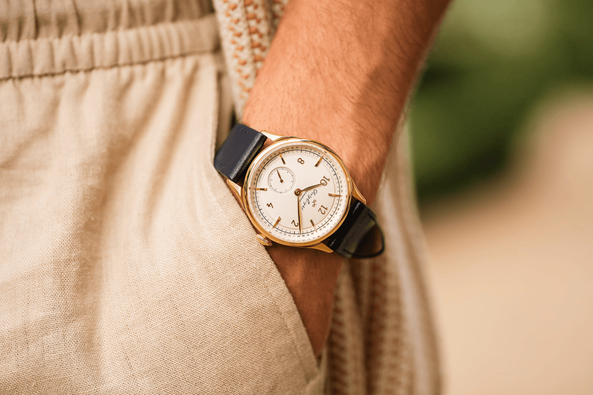 1968 Mechanical, Gold / White by AV86 vintage-inspired automatic with sapphire crystal, detailed dial, and black leather strap on wrist