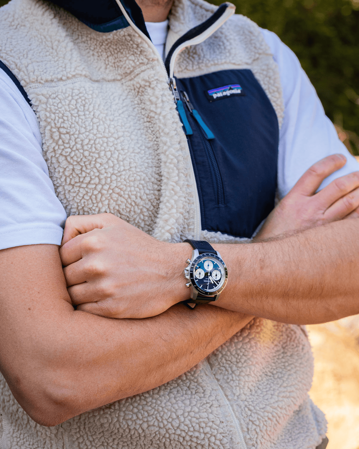 1960 Racing Chronograph by AV86 vintage-inspired chronograph with sapphire crystal, racing dial, and black leather strap on wrist outdoors