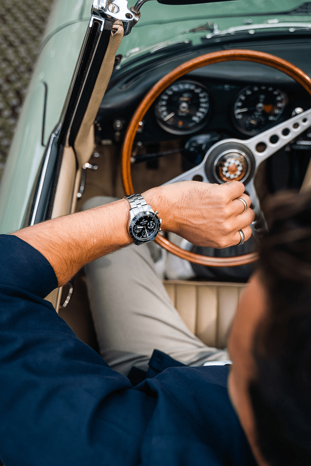 1960 Racing Chronograph by AV86 with sapphire crystal, vintage-inspired dial, steel bracelet, worn in classic car setting