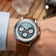 1564 Chronodate Automatic by AV86 features a vintage-inspired automatic chronograph with a textured ice blue dial, sapphire crystal, and a brown leather strap, presented in a minimalist Scandinavian lifestyle setting.