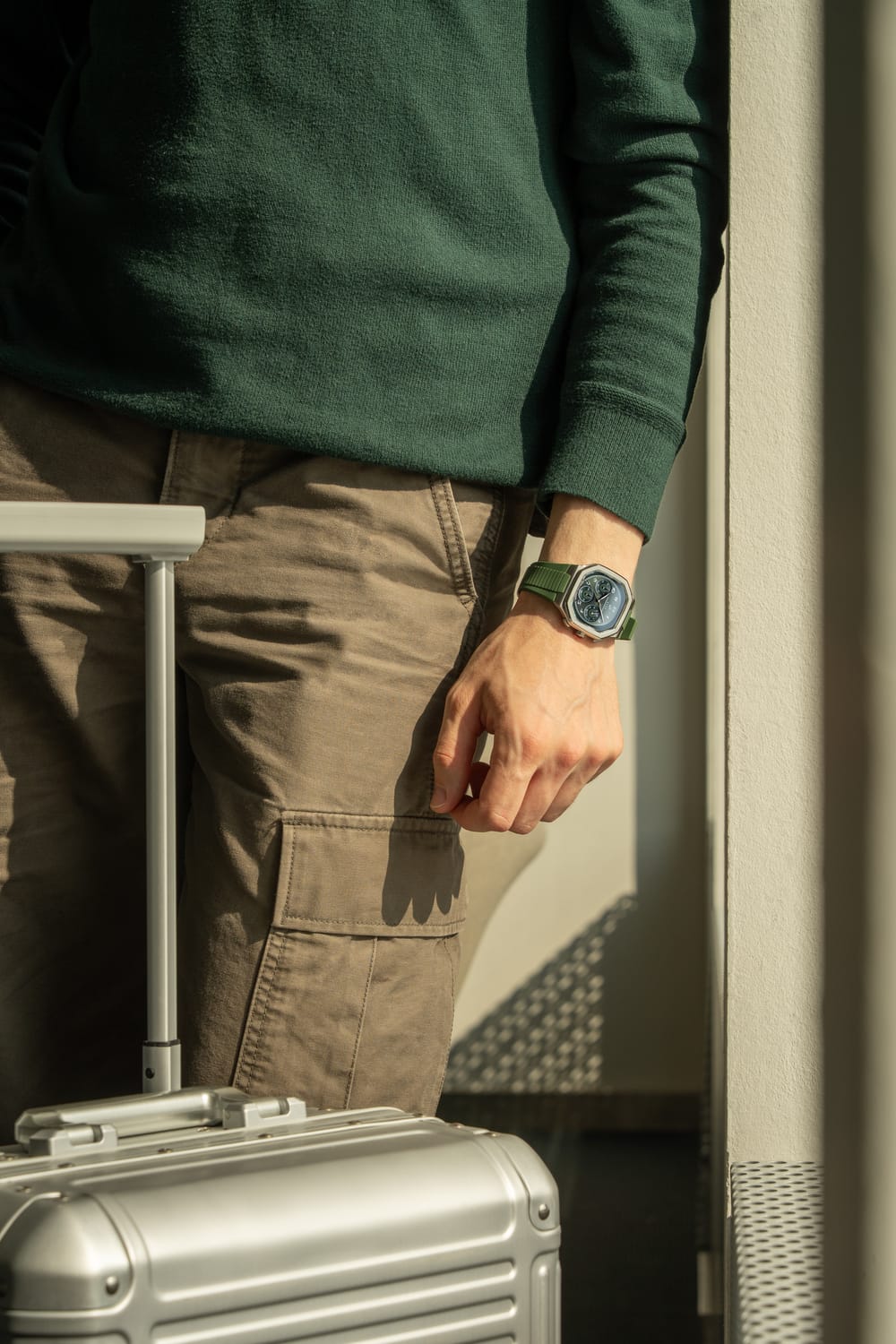 1904 Chronograph by AV86 with angular case, sapphire crystal, chronograph dial, and green fabric strap in casual travel setting