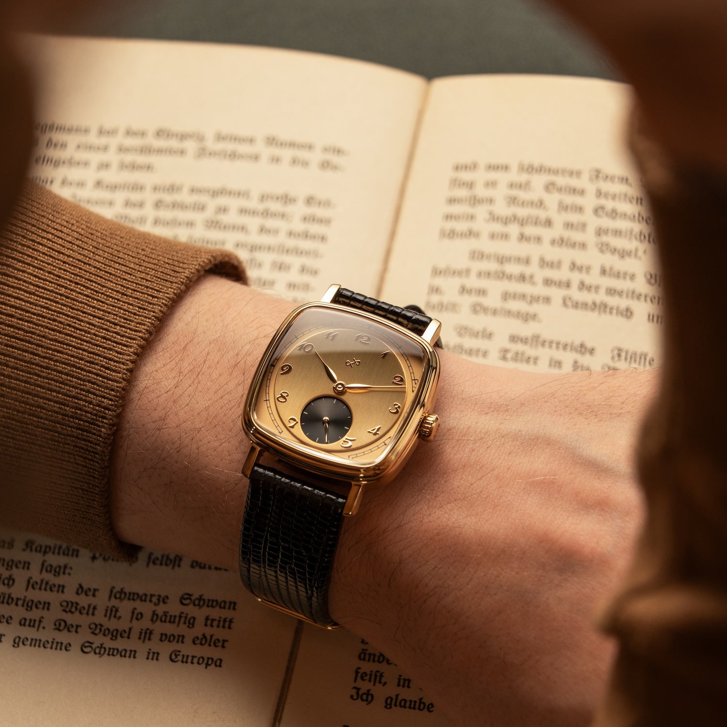 1954 Amalfi Mechanical by AV86, vintage-inspired automatic watch with sapphire crystal and leather strap in a classic setting with book pages