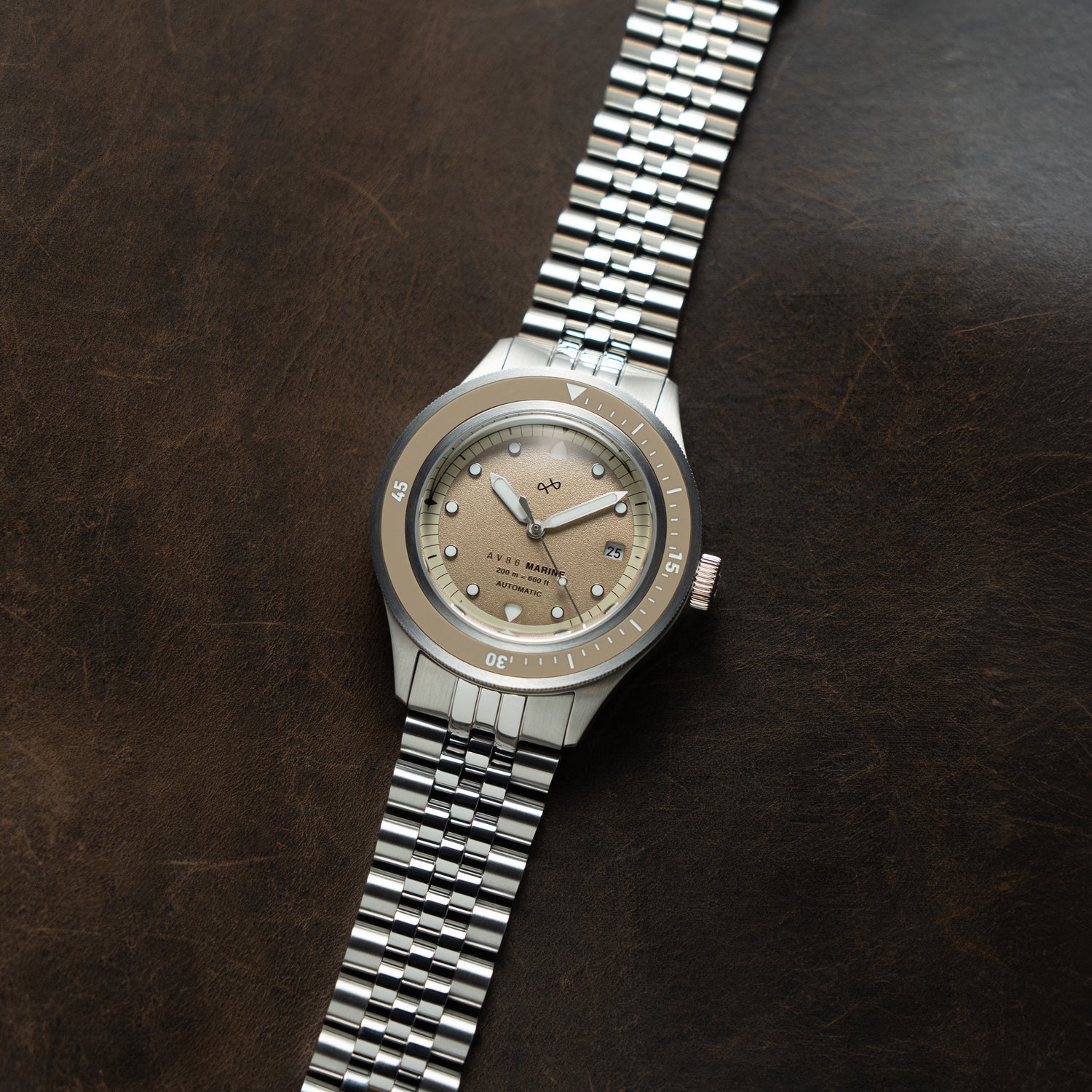 1956 Marine Automatic, Steel / Sand wristwatch by AV86 with a steel bracelet and sand-colored dial on dark brown background