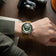 1956 Marine Automatic, Steel / Green on wrist with brown leather strap, showcasing vintage-inspired luxury by AV86.