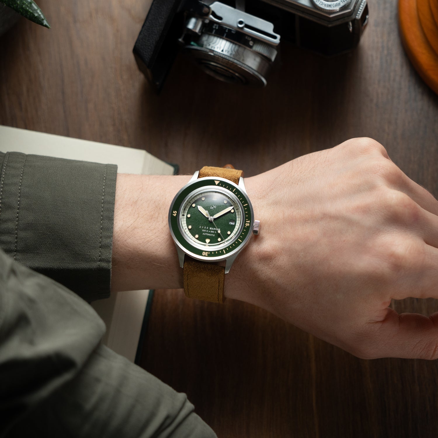 1956 Marine Automatic, Steel / Green on wrist with brown leather strap, showcasing vintage-inspired luxury by AV86.