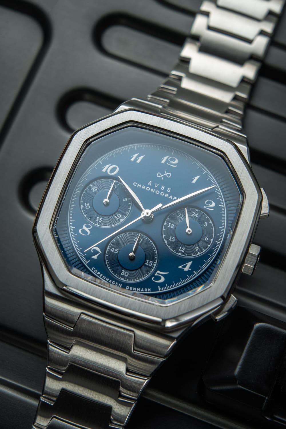 1904 Chronograph by AV86 with angular case, sapphire crystal, chronograph subdials, and brushed metal bracelet strap