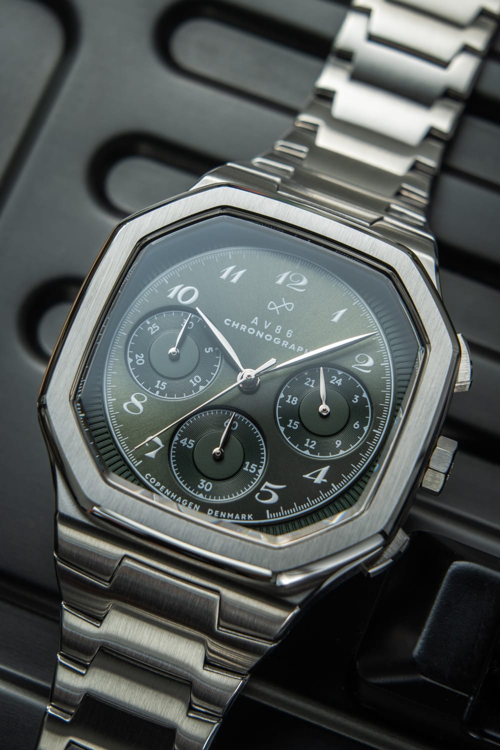 1904 Chronograph by AV86 with angular case, olive green vintage-inspired dial, sapphire crystal, and metal bracelet strap