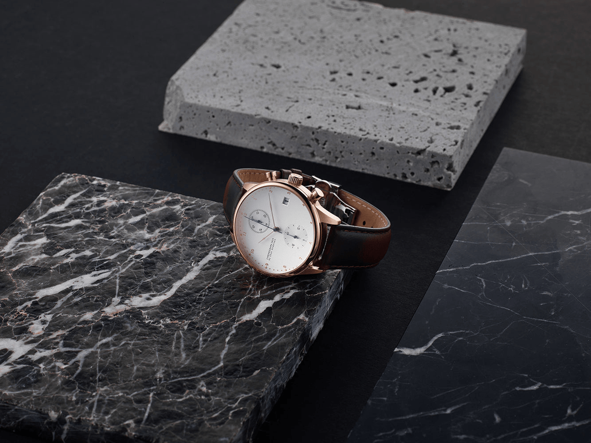 1815 Chronograph by AV86 luxury chronograph with sapphire crystal, vintage-inspired dial, and black leather strap on marble surface