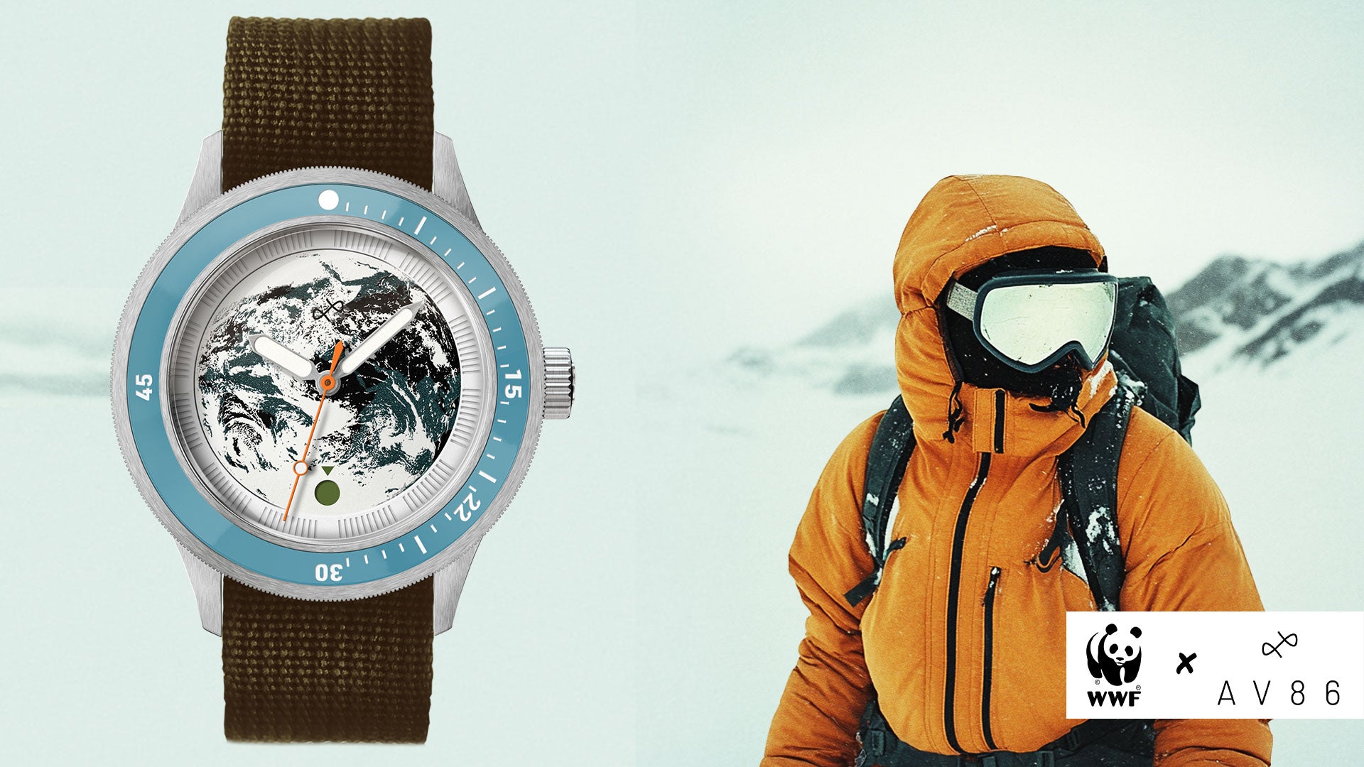 Wristwatch with earth-themed dial and blue bezel beside a person in orange winter gear wearing goggles in a snowy landscape